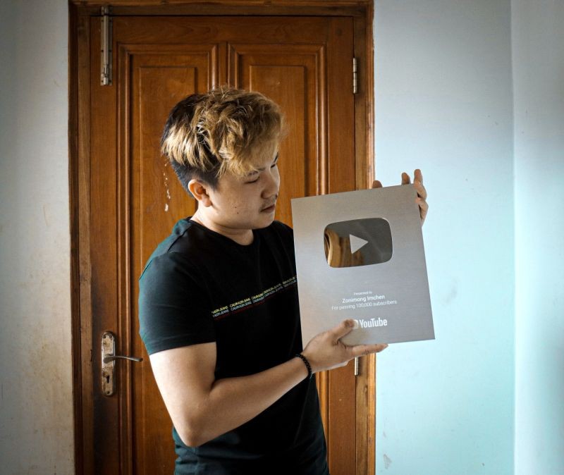 Zonimong Imchen poses with the YouTube’s ‘Silver Play Button’ for 100K subscribers